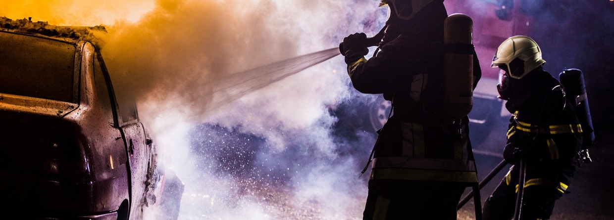 Twee brandweerlieden blussen van een brandende auto met water, schade particulier, verkeer, brand, autobrand, brandweerlieden, blussen, brand blussen